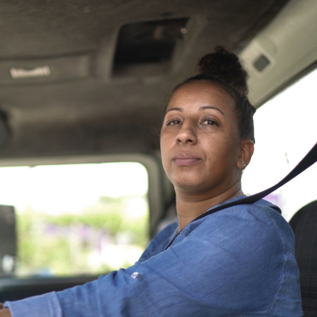 Female driver behind the wheel of a truck