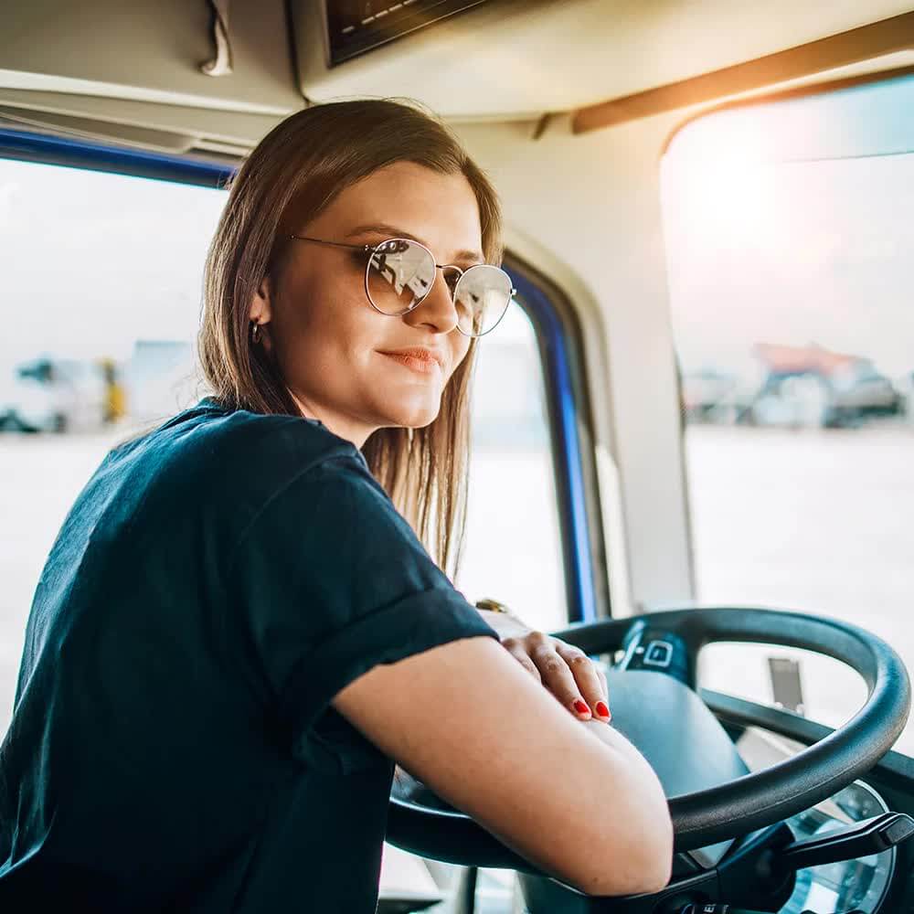 Female truck driver wearing sunglasses